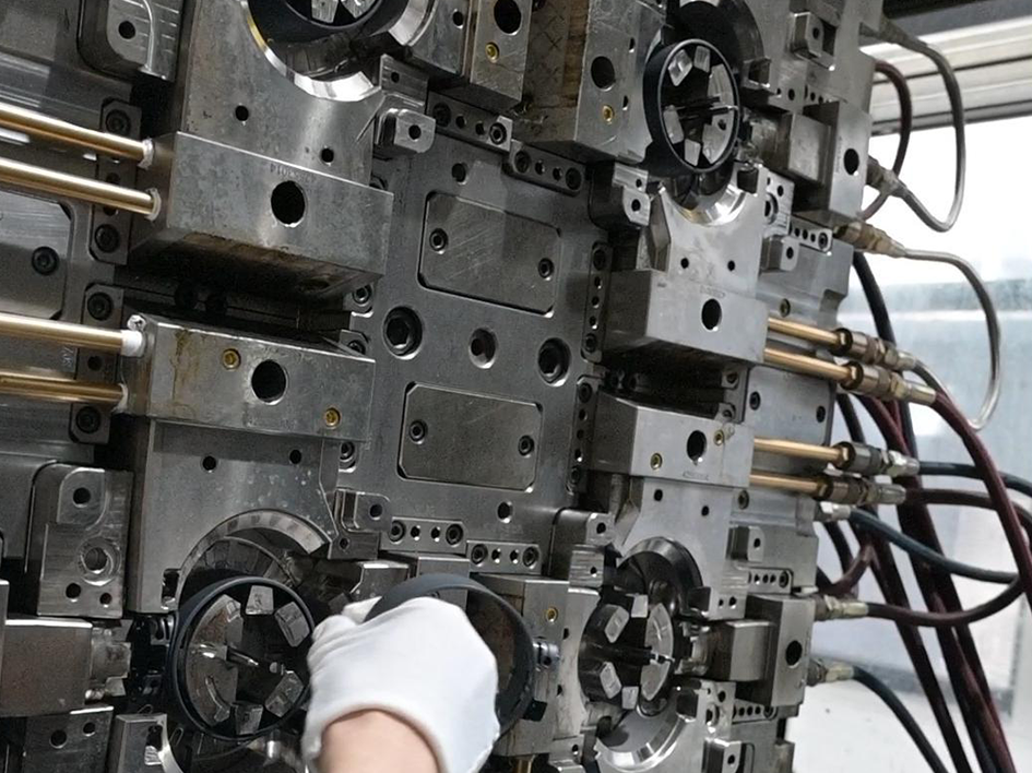 Multi-cavity steel injection mold tool with cooling lines in manufacturing factory