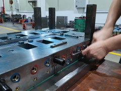 Plastic mold production team inspecting injection mold venting and air control during mold maintenance