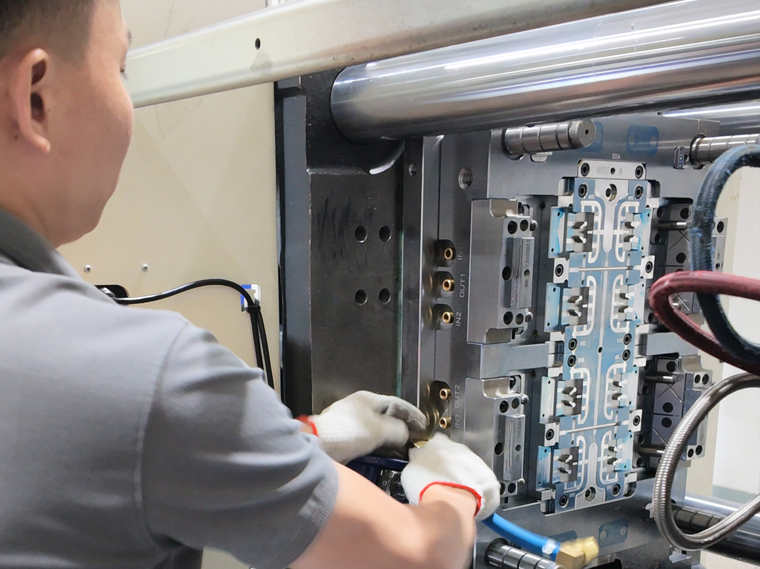 Technician inspecting an injection mold for precision mold manufacturing and stable plastic production