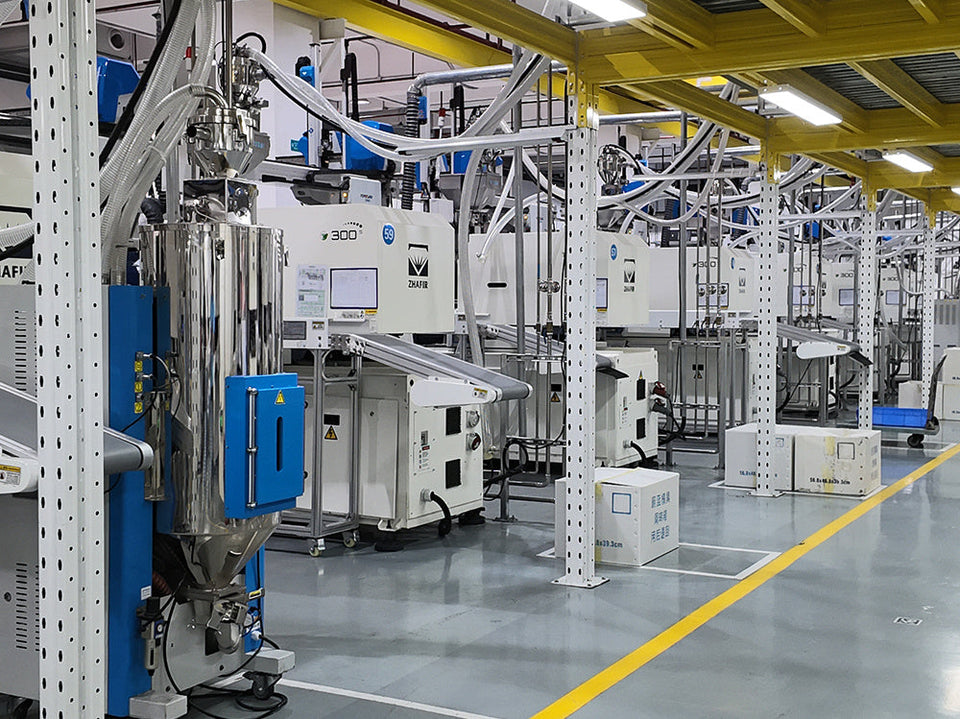 Rows of plastic injection molding machines on a clean factory floor