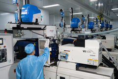 Operator monitors an automated medical injection molding machine inside a clean production room, highlighting process control and stable manufacturing execution.